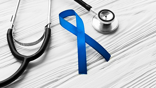 A stethoscope with a blue colon cancer ribbon.