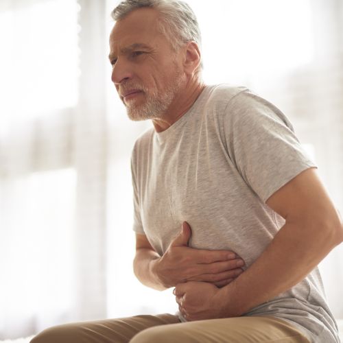 Image of a man having a pain in his stomach
