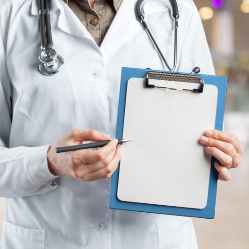 Doctor holding blue clipboard with grey pen.